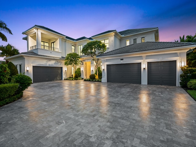 view of front of property with a balcony and a garage