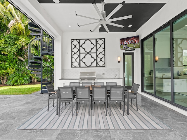 view of patio / terrace with sink, a grill, and ceiling fan