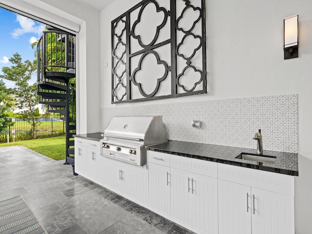 view of patio / terrace with sink, a grill, and an outdoor kitchen