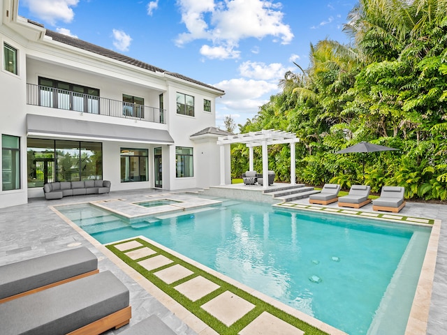 view of pool with an in ground hot tub, a patio area, and a pergola