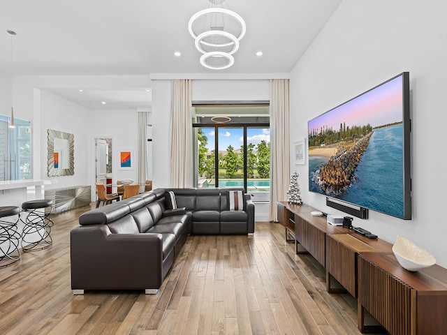 living room featuring a chandelier and light hardwood / wood-style flooring