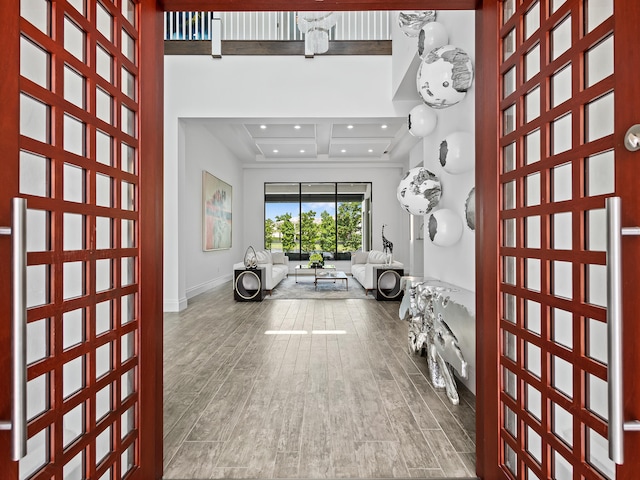 interior space with beam ceiling and wood-type flooring