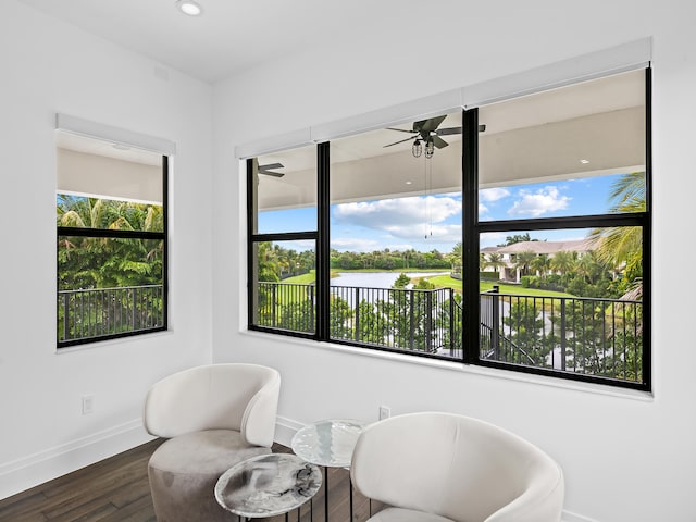 sitting room with ceiling fan and dark hardwood / wood-style flooring