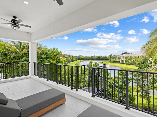 balcony with a water view and ceiling fan