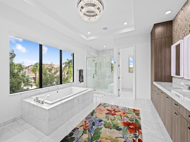 bathroom with vanity, an inviting chandelier, and plus walk in shower