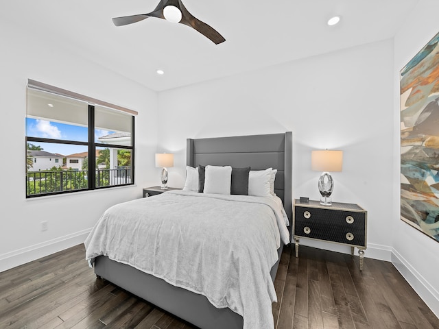 bedroom with dark hardwood / wood-style floors and ceiling fan