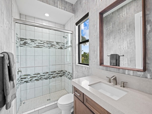 bathroom with vanity, toilet, and an enclosed shower