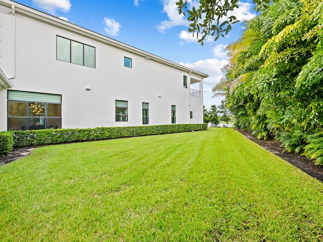 rear view of property with a yard