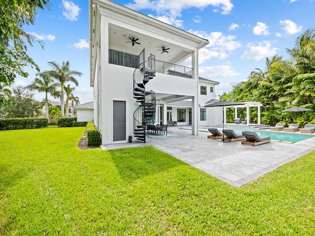 rear view of property with a yard, a patio, and ceiling fan