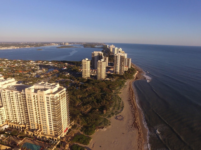 drone / aerial view featuring a water view and a beach view