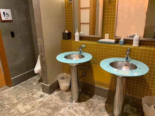 bathroom with tile walls and sink