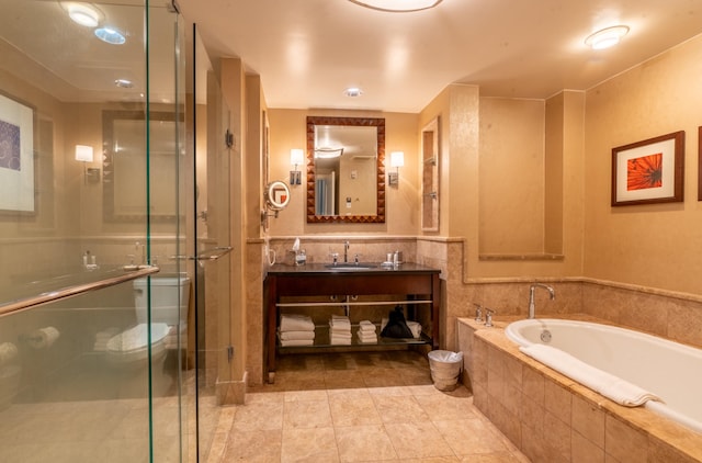 bathroom featuring vanity, shower with separate bathtub, and tile patterned floors