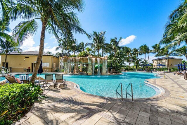 view of pool featuring pool water feature and a patio