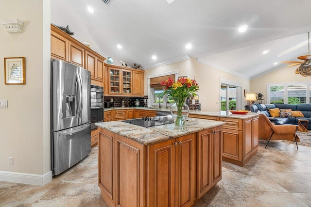 kitchen with ceiling fan, a center island, stainless steel appliances, lofted ceiling, and ornamental molding