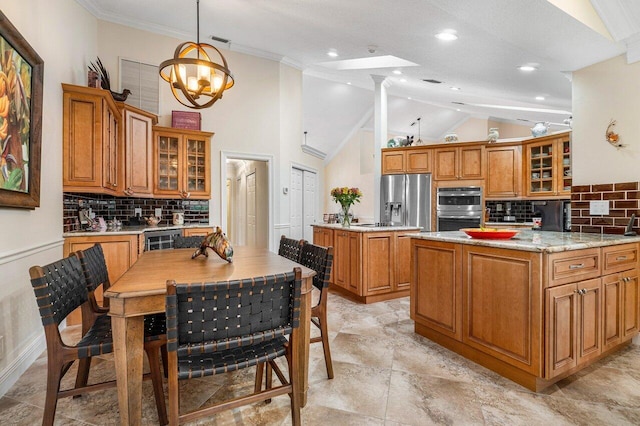 kitchen with lofted ceiling with skylight, decorative light fixtures, appliances with stainless steel finishes, tasteful backsplash, and a notable chandelier