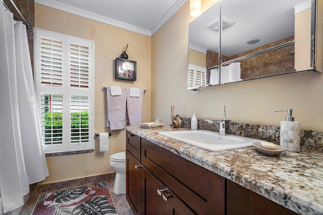 bathroom featuring tile patterned flooring, crown molding, a textured ceiling, toilet, and vanity