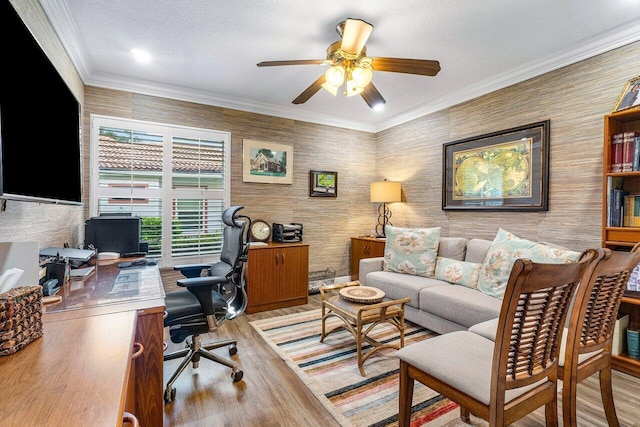 office area featuring a textured ceiling, light wood-type flooring, ceiling fan, and crown molding