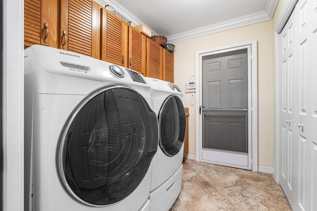 laundry area with cabinets, crown molding, washer and dryer, and a textured ceiling