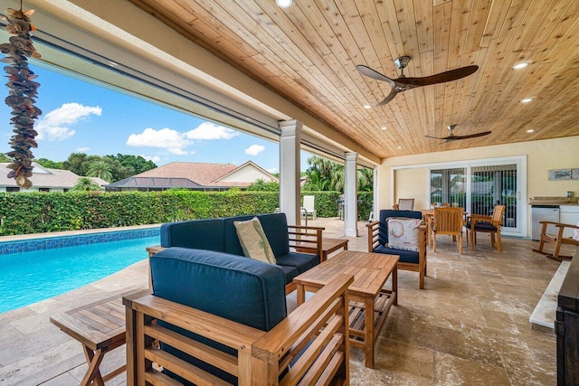 view of pool with ceiling fan, an outdoor living space, and a patio