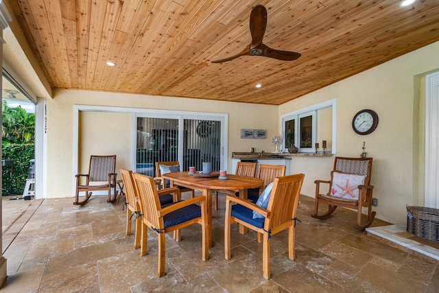 dining area featuring ceiling fan and wooden ceiling