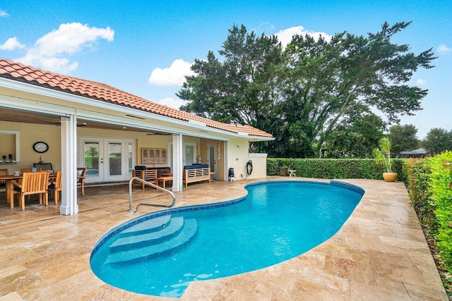 view of pool featuring french doors and a patio area