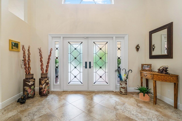 foyer with french doors and a towering ceiling