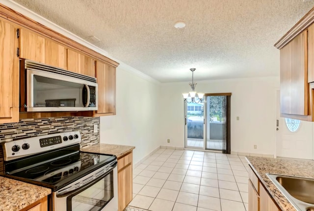 kitchen featuring appliances with stainless steel finishes, decorative light fixtures, an inviting chandelier, decorative backsplash, and light tile patterned floors