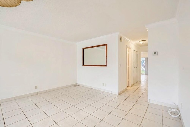 tiled spare room with ornamental molding