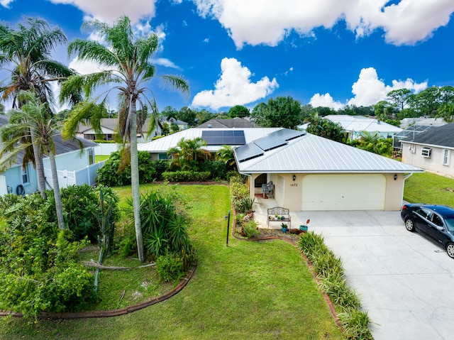 view of front of property with solar panels, a front lawn, and a garage