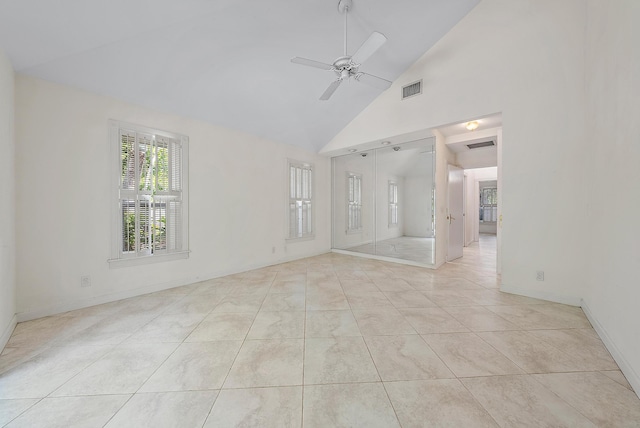 unfurnished room featuring high vaulted ceiling, ceiling fan, and light tile patterned floors