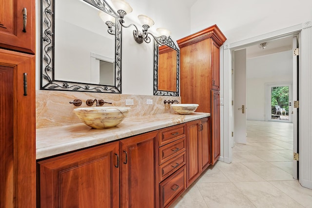 bathroom featuring vanity, tile patterned flooring, and decorative backsplash