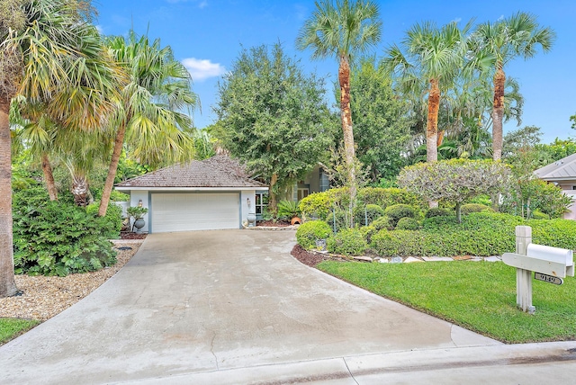 view of front of house with a garage and a front lawn