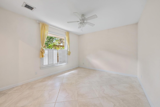 empty room featuring light tile patterned floors and ceiling fan