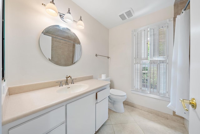 bathroom featuring tile patterned floors, curtained shower, vanity, and toilet