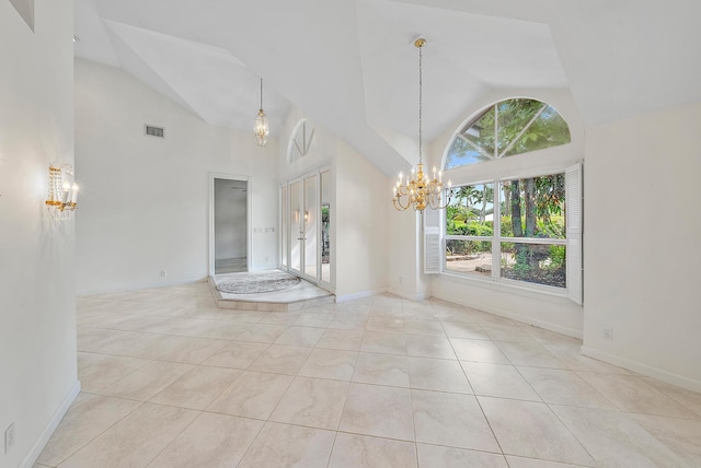 interior space with high vaulted ceiling, a chandelier, light tile patterned floors, and a healthy amount of sunlight