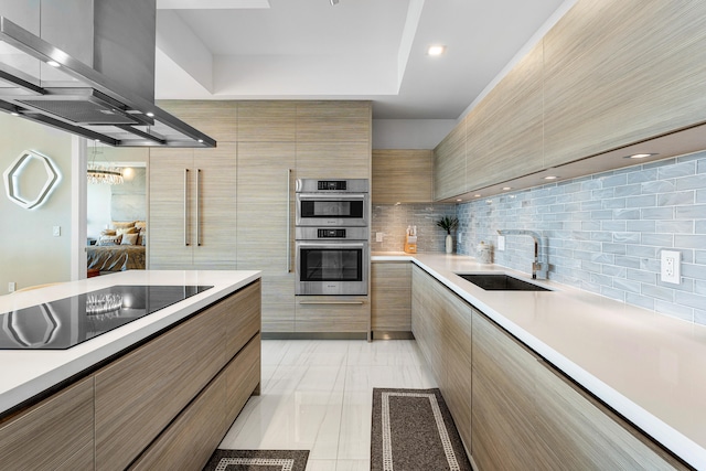 kitchen with black electric stovetop, sink, island range hood, backsplash, and double oven