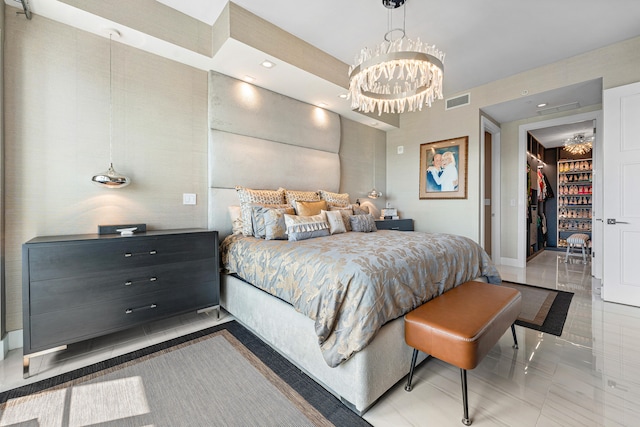 bedroom with an inviting chandelier, a closet, and a walk in closet