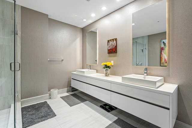 bathroom featuring tile patterned floors, an enclosed shower, and vanity