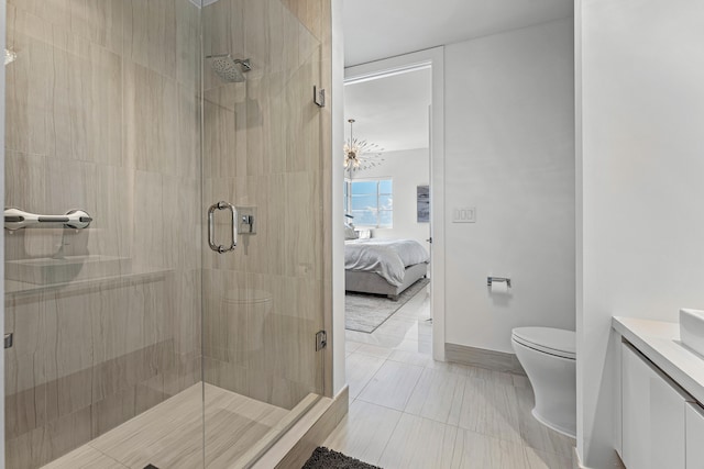 bathroom featuring walk in shower, vanity, toilet, and tile patterned floors