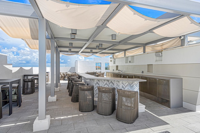 view of patio featuring an outdoor bar