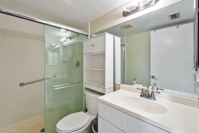 bathroom with vanity, an enclosed shower, and toilet