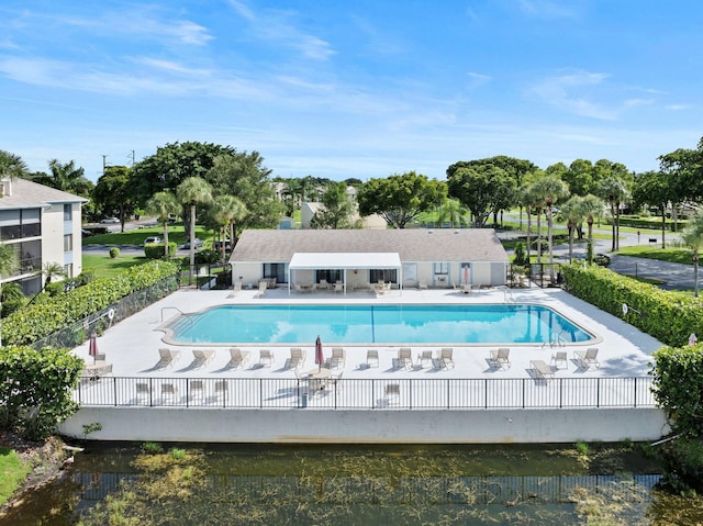 view of pool with a patio area and a water view