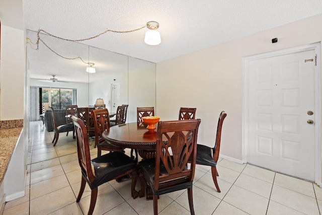 dining space with light tile patterned floors, a textured ceiling, and ceiling fan