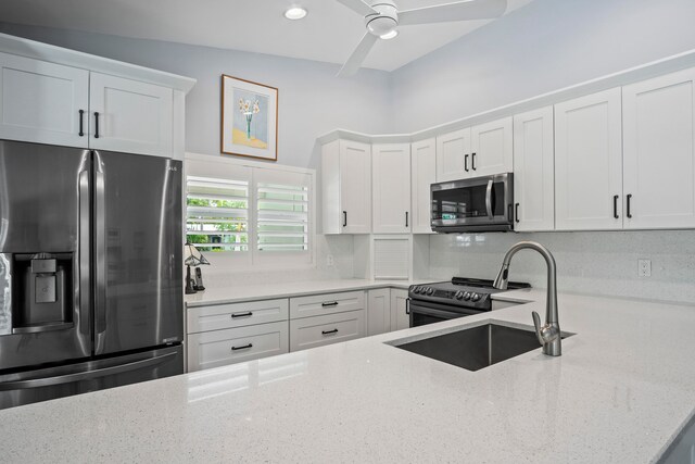 kitchen with appliances with stainless steel finishes, sink, ceiling fan, and white cabinets