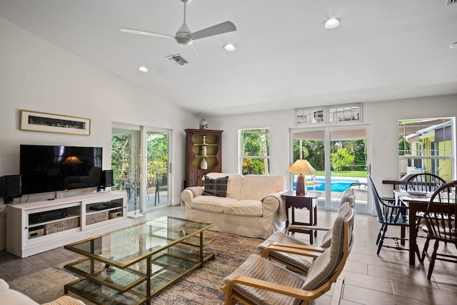 living room featuring vaulted ceiling, ceiling fan, and dark hardwood / wood-style floors