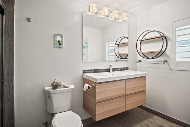 bathroom with wood-type flooring, vanity, and toilet