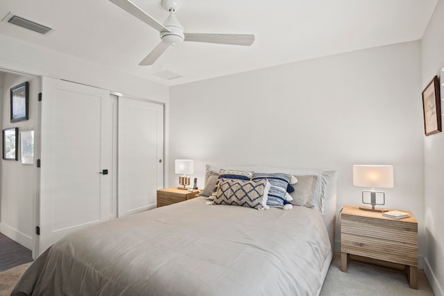 carpeted bedroom featuring a closet and ceiling fan