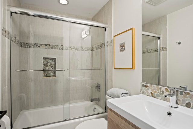 full bathroom featuring enclosed tub / shower combo, backsplash, vanity, and toilet