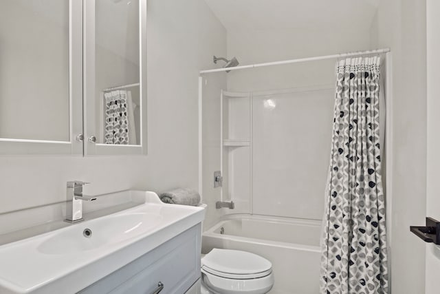 full bathroom with vanity, shower / tub combo, and toilet