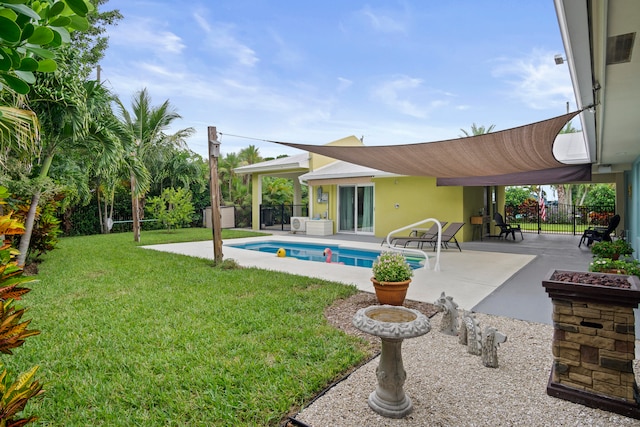 view of swimming pool featuring a yard and a patio area